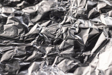 old used crumpled aluminum foil , close up