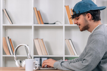 Fototapeta premium student typing on laptop at desk