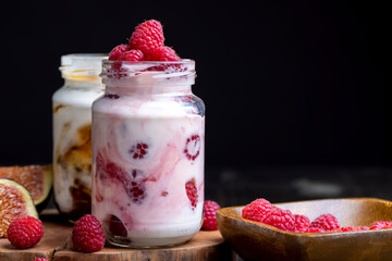 Milk yogurt with raspberries, close up