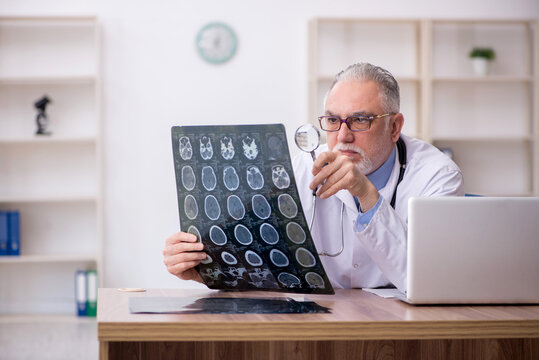 Old male doctor radiologist working in the clinic