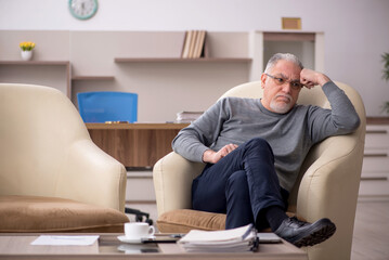 Fototapeta premium Old male employee working from home during pandemic