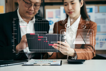 Business team hand Project manager working and update tasks and Gantt chart scheduling virtual diagram.with smart phone, tablet and laptop in office.