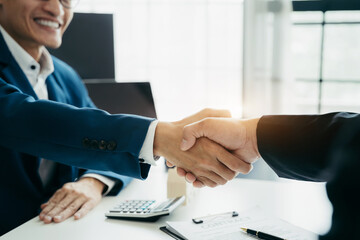 Close up two men shake hands at business meeting, office negotiations. Making deal sign, conclude contract, reach agreement, formal greeting, strike bargain. Successful negotiations.