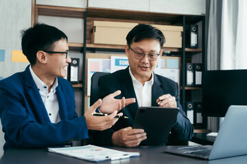 Businessmen team or financial data analysts working with tablets and laptop computers and data graphs together. Plan to analyzing projects in the office.