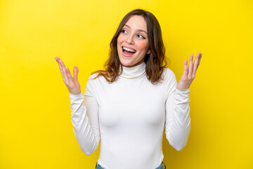 Young caucasian woman isolated on yellow background with surprise facial expression