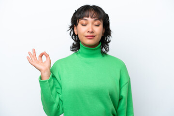 Young Argentinian woman isolated on white background in zen pose