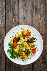 Noodles with clams on wooden table
