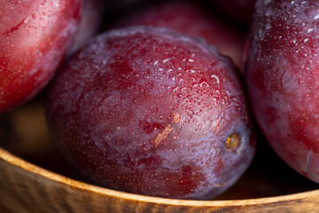 Ripe delicious plums of dark color