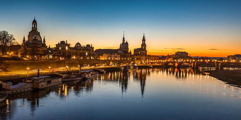 Obraz na płótnie Canvas Dresden city skyline at Elbe river and Augustus Bridge at sunset , Dresden, Saxony, Germany. Panoramic evening view of Dresden.