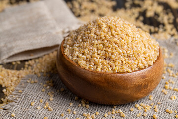 Fresh wheat porridge in a wooden bowl