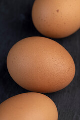 A whole orange chicken egg close-up on the table