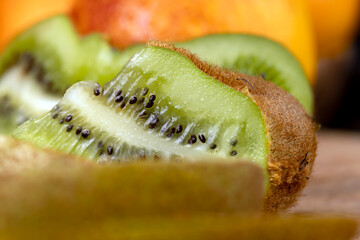 close-up of a green ripe kiwi on a chopping board