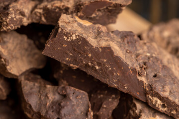 Pieces of chocolate with added cocoa and sugar