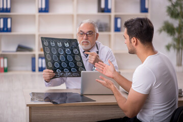 Young male patient visiting old male doctor radiologist