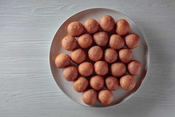 Cottage cheese doughnuts on an old wooden table.