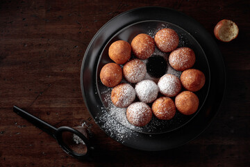 Balls of freshly baked homemade cottage cheese doughnuts.