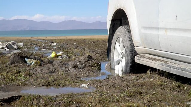 Slow motion view of stuck car in mud