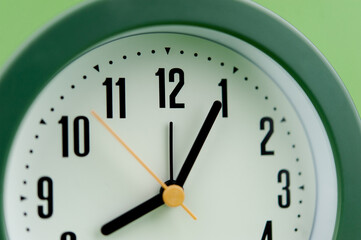 alarm clock on green background time concept working with time precious time