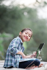A girl is using a laptop computer for education and learning online.