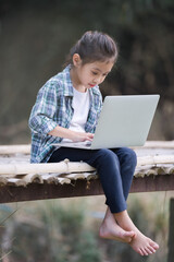 A girl is using a laptop computer for education and learning online.