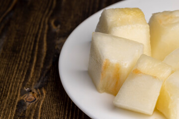 Ripe yellow melon cut into pieces and portions