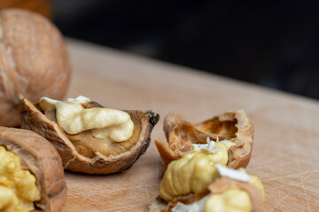 Open and broken walnut shells lying on the table