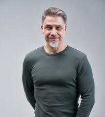 Portrait of happy casual older man smiling, Mid adult, mature age guy standing, isolated on gray background.