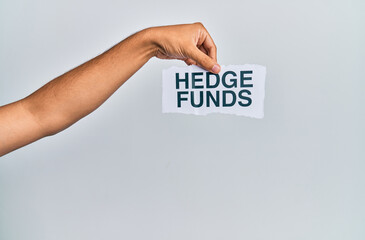 Hand of caucasian man holding paper with hedge funds message over isolated white background