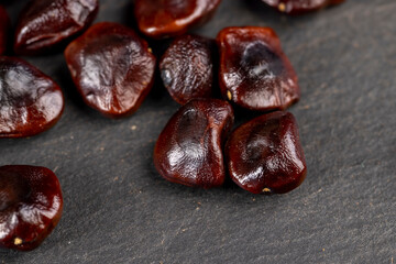 brown tamarind seeds on the table, scattered seeds