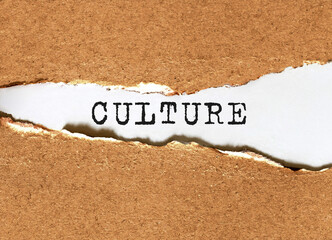 Text Culture appearing behind torn brown paper