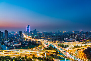Fototapeta na wymiar Night view of Saihong Bridge and city skyline in Nanjing, Jiangsu, China