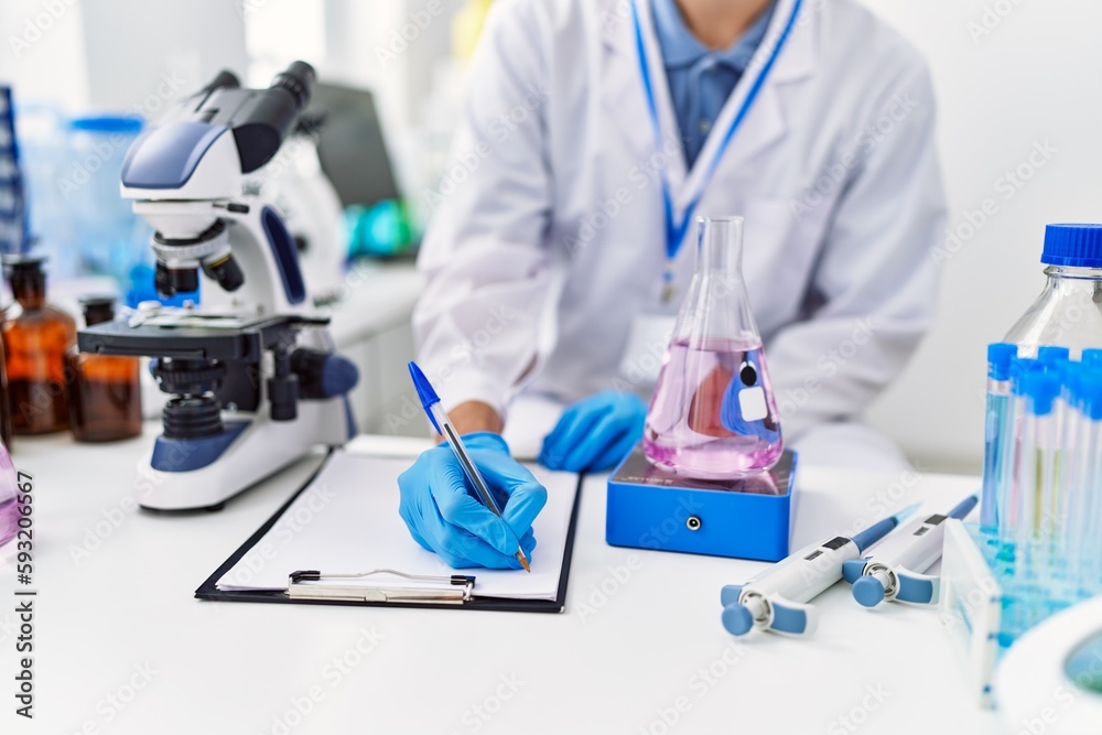 Sticker Young blond man scientist writing on document weighing test tube at laboratory