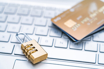 Lock and stack of credit cards on laptop keyboard
