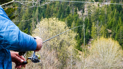 A fisherman holding his fishing rod.