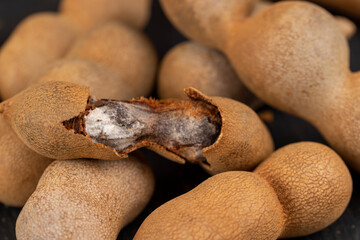 open ripe tamarind pods with edible pulp