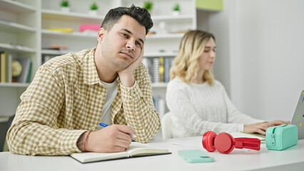 Man and woman students using laptop writing notes sleeping at library university