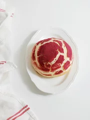 Fotobehang Vertical shot of a red crinkle cookie with crackles on a plate © Jingluo/Wirestock Creators