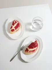 Fotobehang Vertical shot of a cut red crinkle cookie with crackles on plates © Jingluo/Wirestock Creators