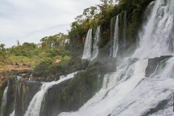 Landscape scene of Iguazu waterfalls with trees in Argentina with blue sky