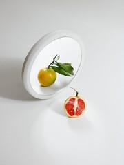 Vertical shot of a red orange in the mirror