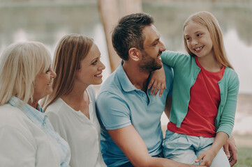 Happy multi-generation family spending carefree time outdoors together