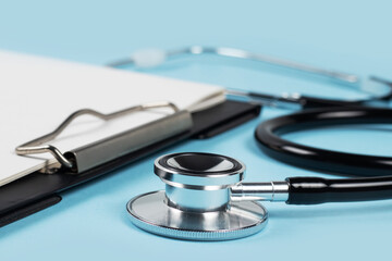 blank clipboard with modern stethoscope, space for messages