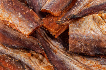 Pieces of cleaned dried fishbackground. Dry Peppered Pollack. Amber with pepper Collection