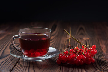 Organic viburnum tea, hot autumn drink with fresh viburnum berries. Viburnum tea with honey and cinnamon