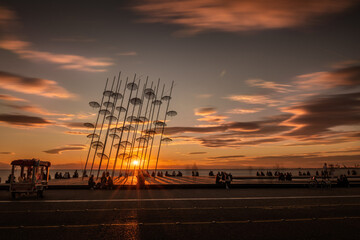 Beautiful sunset over the Zongolopoulos umbrellas and the beach in Thessaloniki, Greece.