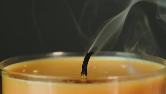 Extinguish match lights candle in macro