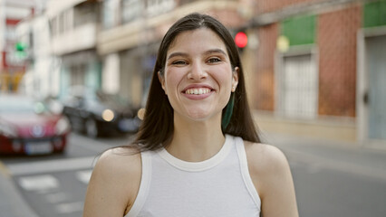 Young beautiful hispanic woman smiling confident standing at street