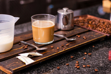 Barista creating a heart shaped coffee art design.