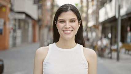 Young beautiful hispanic woman smiling confident standing at street