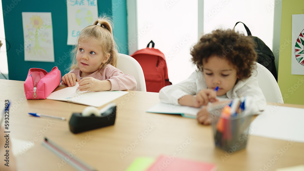 Sticker Boy and girl students sitting on table drawing on notebook at classroom